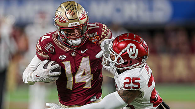 Florida State Seminoles receiver Johnny Wilson catches a pass against Oklahoma Sooners defensive back Justin Broiles in the 2022 Cheez-It Bowl at Camping World Stadium.
